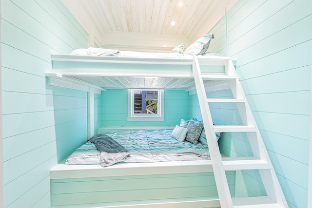 bedroom featuring wood walls and wood ceiling