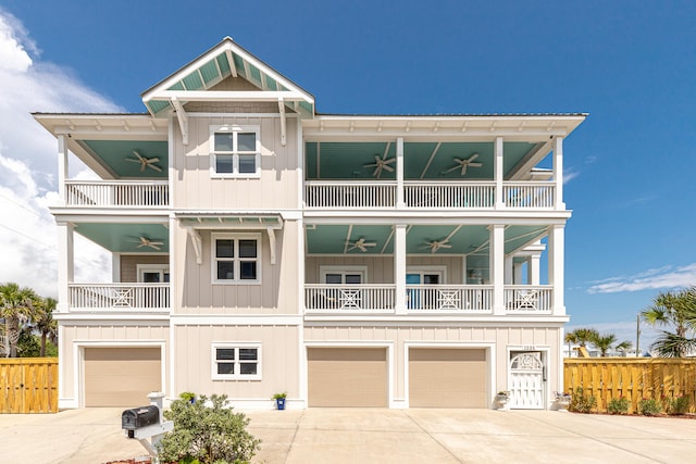 raised beach house featuring a balcony and a garage