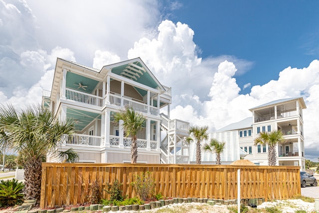 raised beach house with ceiling fan and a balcony