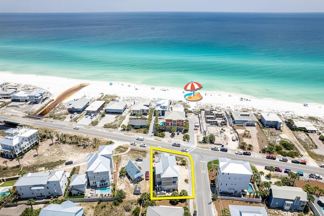 drone / aerial view with a beach view and a water view