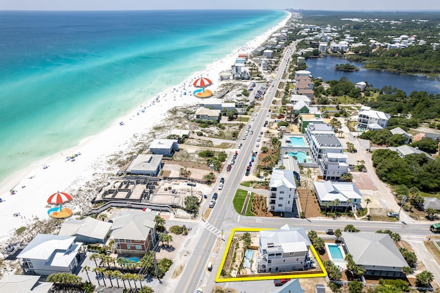 bird's eye view featuring a water view and a view of the beach