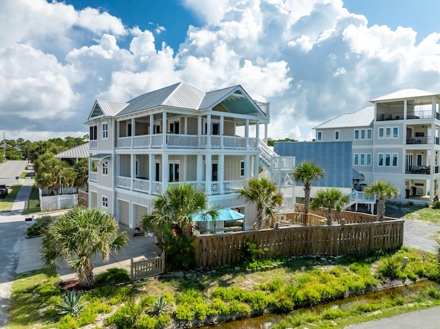 1235 Allen Loop Dr, Santa Rosa Beach, FL 32459 - rear view of property featuring a balcony, a metal roof, and an attached garage