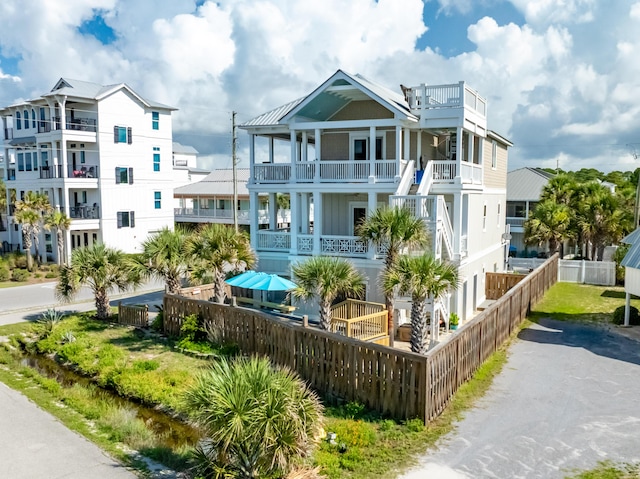 1235 Allen Loop Dr, Santa Rosa Beach, FL 32459 - view of front of property featuring a fenced front yard, a balcony, and board and batten siding