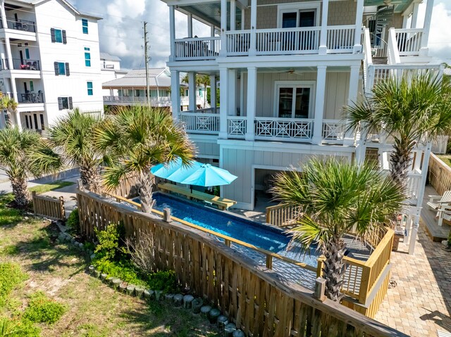 1235 Allen Loop Dr, Santa Rosa Beach, FL 32459 - back of property featuring board and batten siding, a balcony, and a fenced backyard