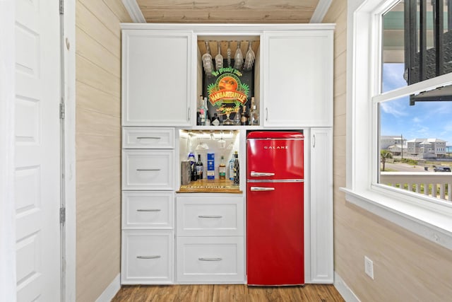 1235 Allen Loop Dr, Santa Rosa Beach, FL 32459 - indoor dry bar with refrigerator and wood finished floors