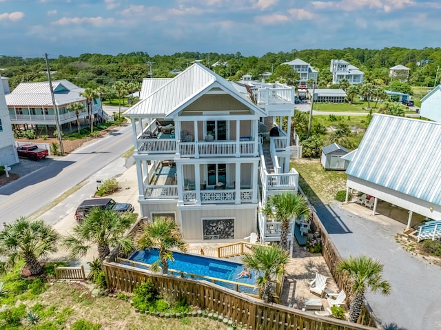1235 Allen Loop Dr, Santa Rosa Beach, FL 32459 - back of house featuring a balcony, stairs, and an outdoor pool