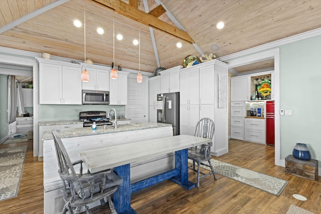 1235 Allen Loop Dr, Santa Rosa Beach, FL 32459 - kitchen featuring stainless steel appliances, a center island with sink, high vaulted ceiling, white cabinetry, and hanging light fixtures