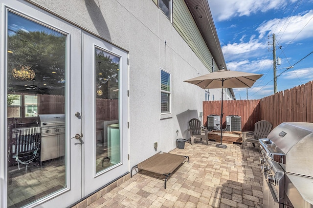 view of patio with cooling unit, fence, and a grill