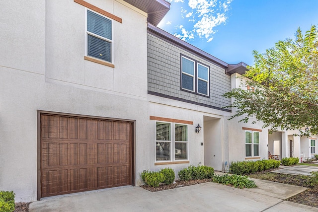 view of front facade with an attached garage and stucco siding