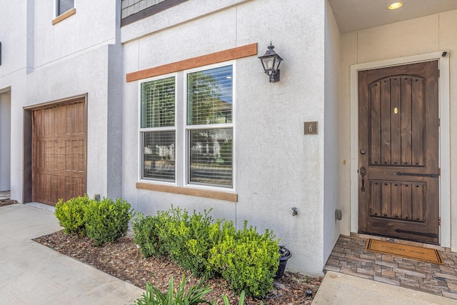 property entrance with stucco siding