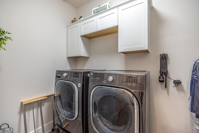 laundry room with washer and clothes dryer and cabinet space