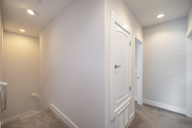 hall with recessed lighting, carpet flooring, visible vents, and baseboards