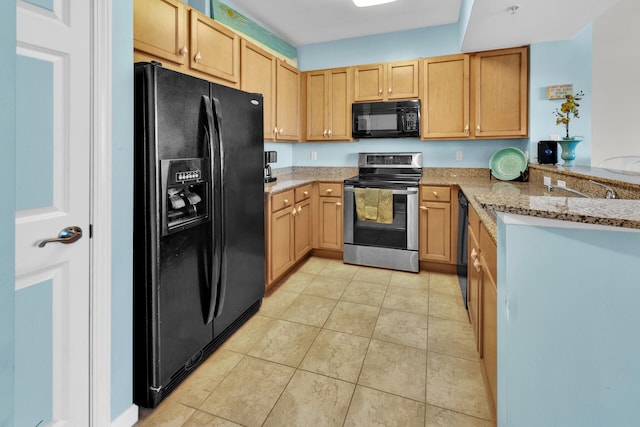 kitchen featuring light tile floors, black appliances, and light stone countertops