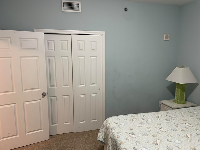 bedroom featuring a closet and dark carpet