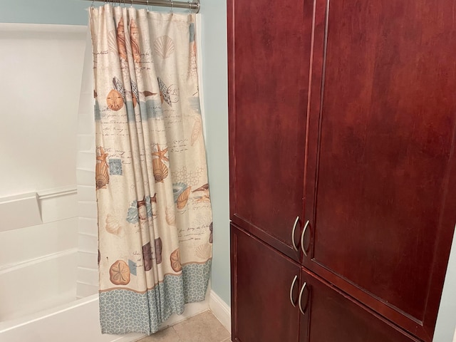 bathroom with tile flooring and shower / bathtub combination with curtain