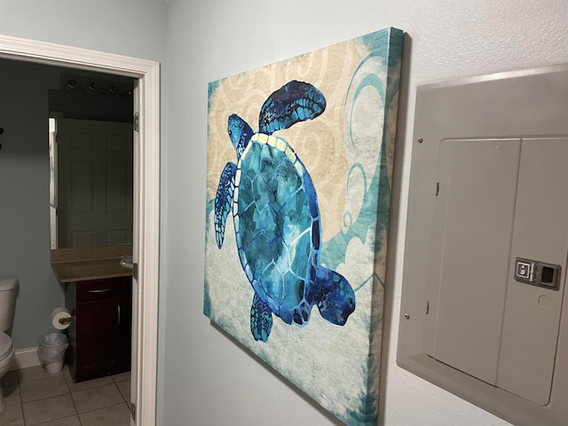 interior space with vanity, toilet, and tile flooring