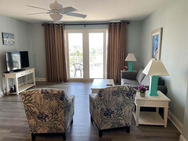 living room with ceiling fan and dark wood-type flooring