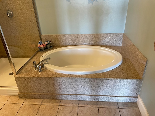 bathroom with tile flooring and independent shower and bath