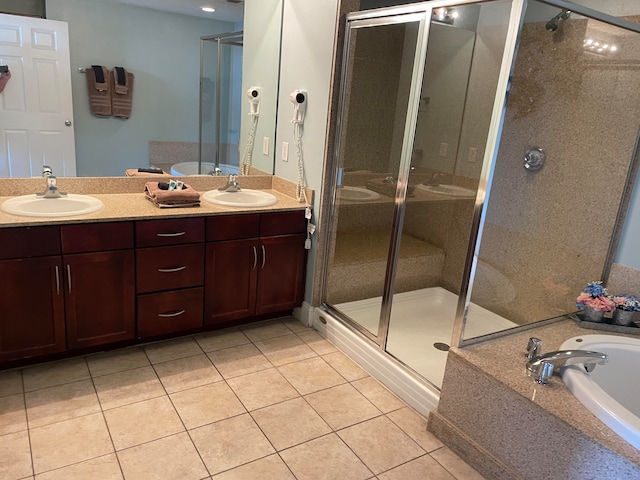 bathroom featuring double sink, shower with separate bathtub, oversized vanity, and tile floors