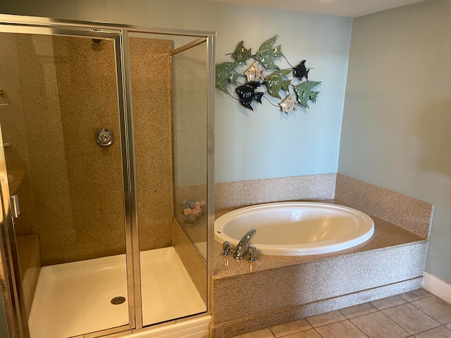 bathroom featuring tile flooring and separate shower and tub