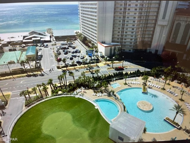 view of swimming pool with a water view