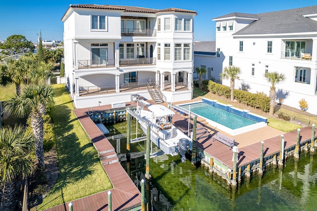 24 Norriego Rd, Destin, FL 32541 - rear view of house with a balcony, a yard, and a fenced in pool