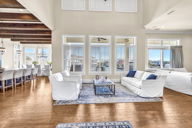24 Norriego Rd, Destin, FL 32541 - living room featuring ceiling fan with notable chandelier, dark hardwood / wood-style flooring, and beam ceiling