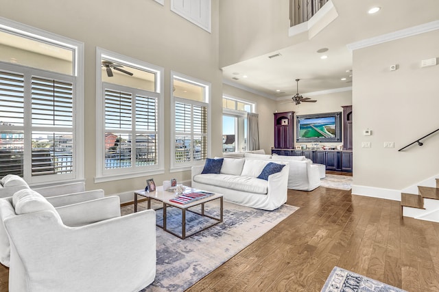 24 Norriego Rd, Destin, FL 32541 - living room featuring ceiling fan, crown molding, a towering ceiling, and dark hardwood / wood-style floors