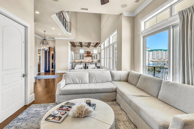 24 Norriego Rd, Destin, FL 32541 - living room with wood-type flooring, crown molding, and an inviting chandelier