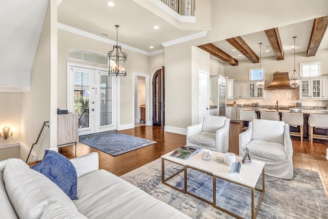 24 Norriego Rd, Destin, FL 32541 - living room featuring plenty of natural light, dark wood-type flooring, and a notable chandelier