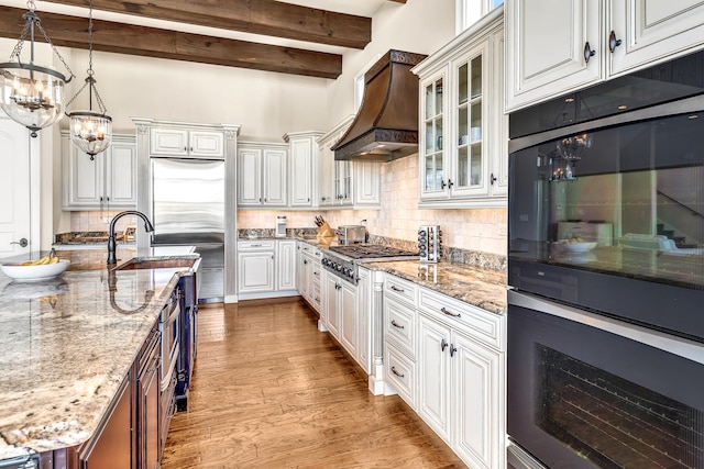 24 Norriego Rd, Destin, FL 32541 - kitchen with custom range hood, backsplash, light wood-type flooring, and white cabinets