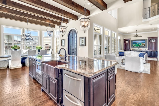 24 Norriego Rd, Destin, FL 32541 - kitchen featuring decorative light fixtures, a center island with sink, ceiling fan with notable chandelier, and dark hardwood / wood-style floors