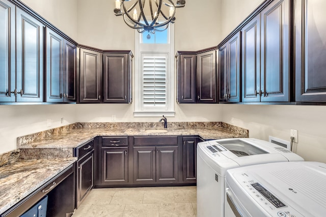 24 Norriego Rd, Destin, FL 32541 - laundry area with washer and dryer, cabinets, light tile floors, sink, and an inviting chandelier