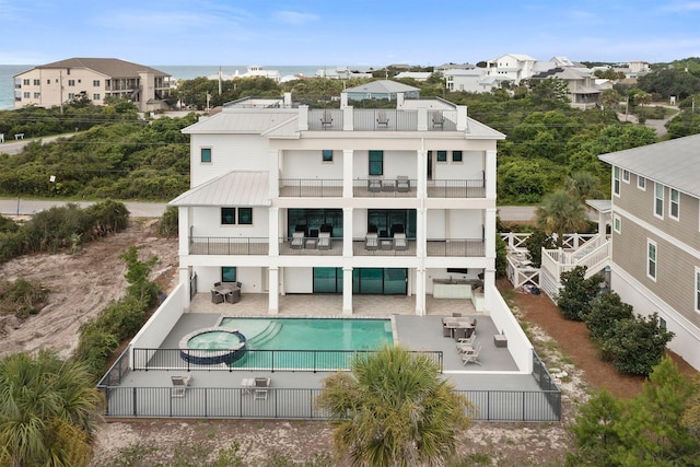 back of property featuring a patio area and a balcony