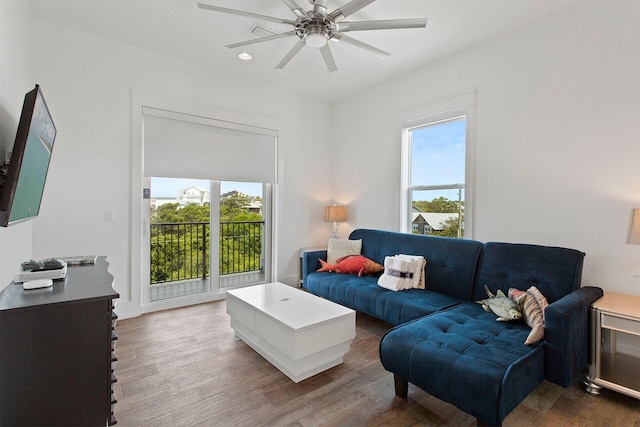 living room with dark hardwood / wood-style flooring and ceiling fan