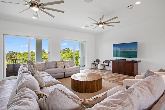 living room with ceiling fan and light wood-type flooring