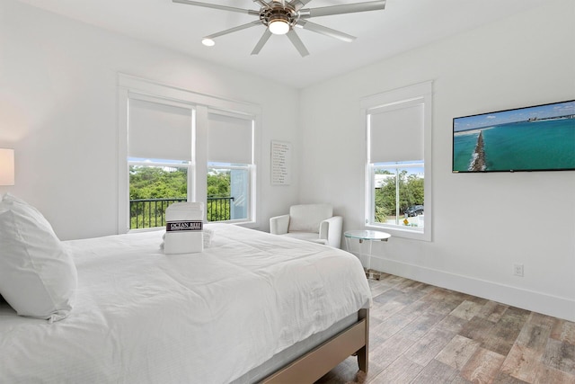 bedroom with ceiling fan, light wood-type flooring, and access to outside