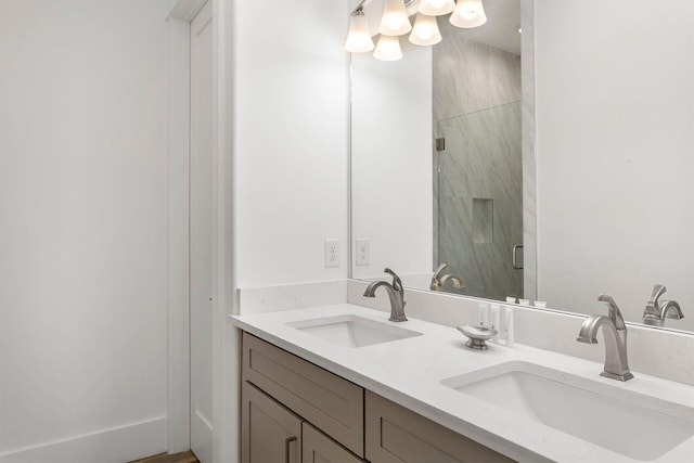 bathroom featuring walk in shower and dual bowl vanity