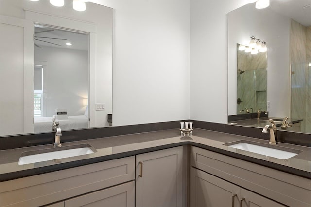 bathroom with a shower, double vanity, and ceiling fan