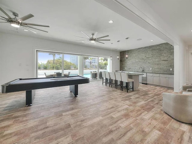 recreation room featuring light hardwood / wood-style floors, ceiling fan, a wealth of natural light, and pool table