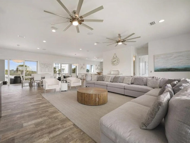 living room featuring light hardwood / wood-style floors and ceiling fan