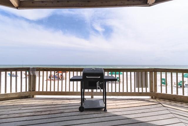 wooden terrace featuring a water view