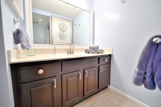 bathroom featuring tile flooring and vanity