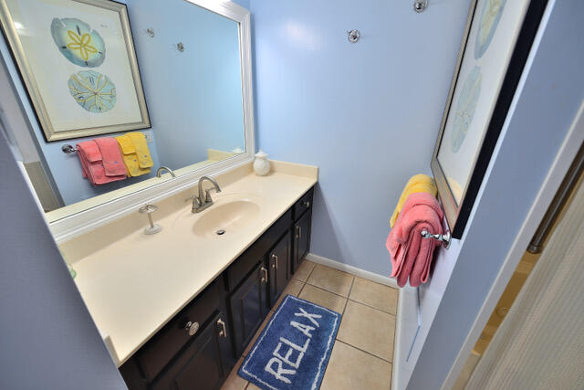 bathroom featuring tile flooring and oversized vanity