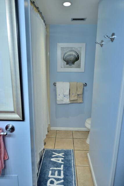 bathroom with tile floors and toilet