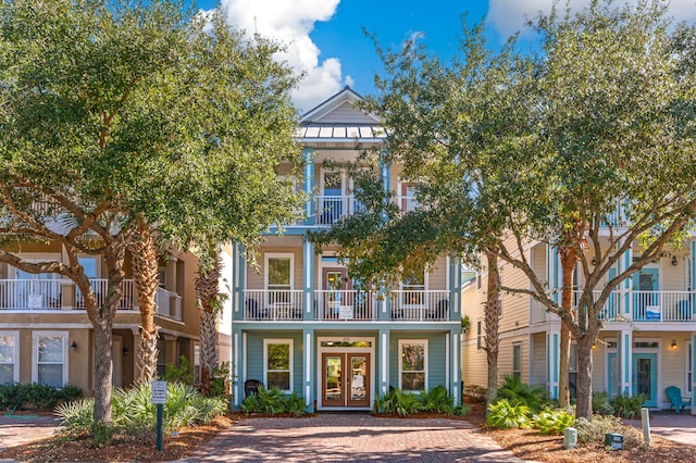 view of front of property featuring french doors and a balcony