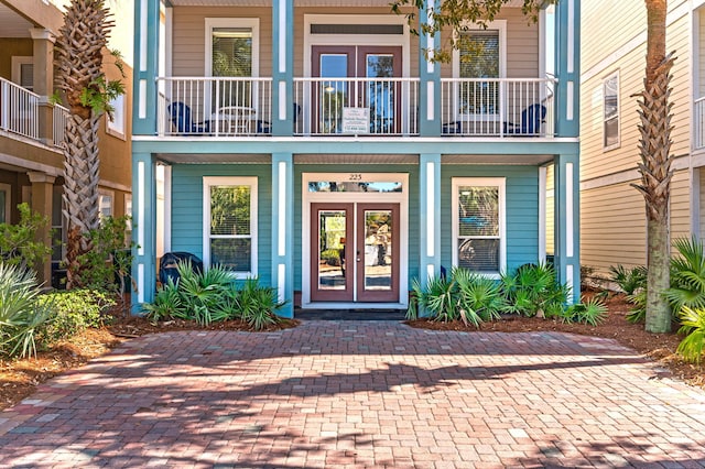 property entrance featuring french doors and a balcony