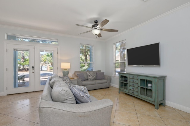 living room with french doors, ornamental molding, ceiling fan, and light tile flooring