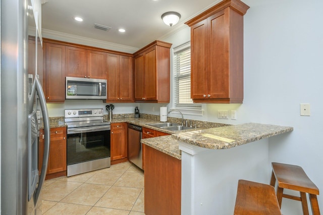 kitchen featuring light stone counters, light tile floors, sink, crown molding, and stainless steel appliances