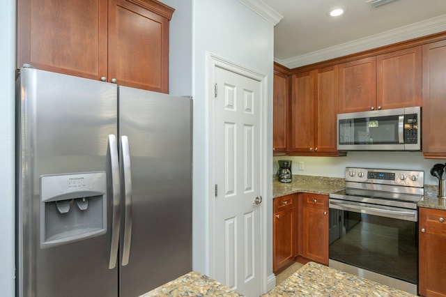 kitchen featuring crown molding, appliances with stainless steel finishes, and light stone counters